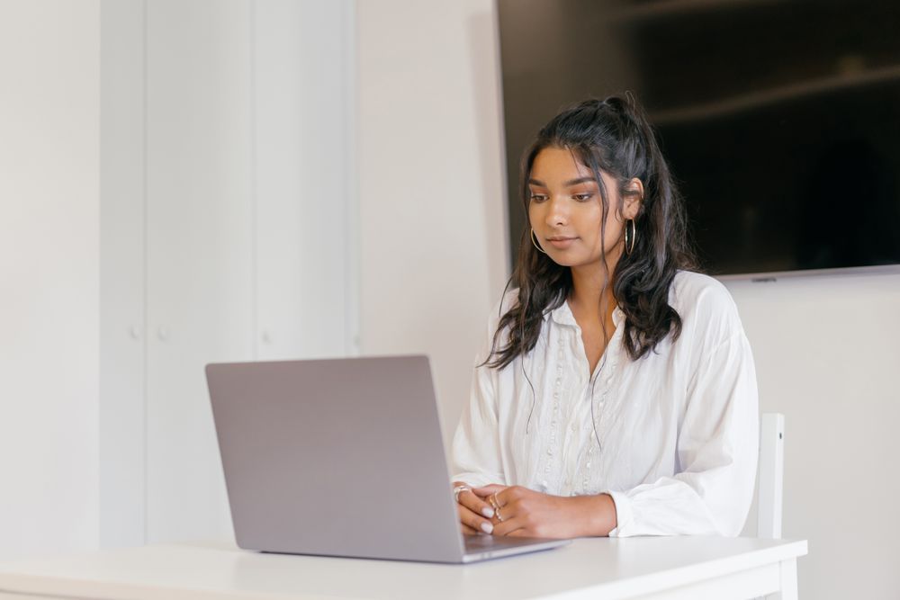 A young woman studying at her laptop
